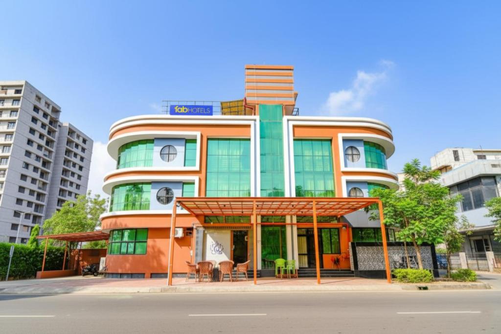 a tall building with a sign on top of it at Fabhotel Siddharth Corporate in Gandhinagar