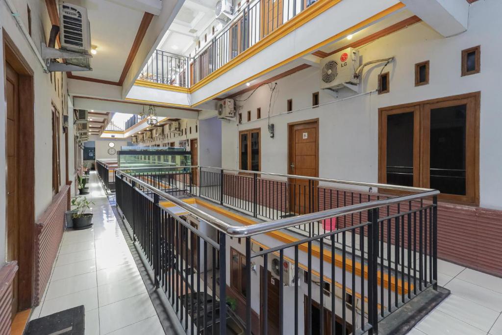 an empty hallway of a building with a balcony at RedDoorz near Juanda International Airport 2 in Sidoarjo