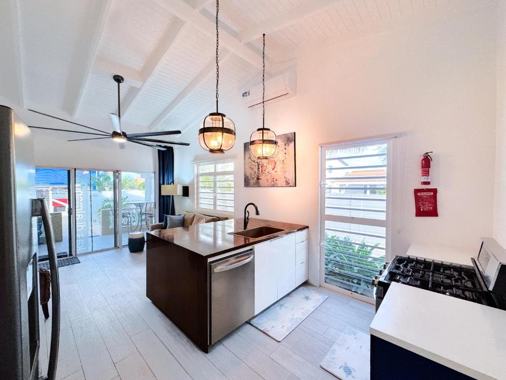 a kitchen with a sink and a stove at Treasure By The Sea Bonaire in Kralendijk