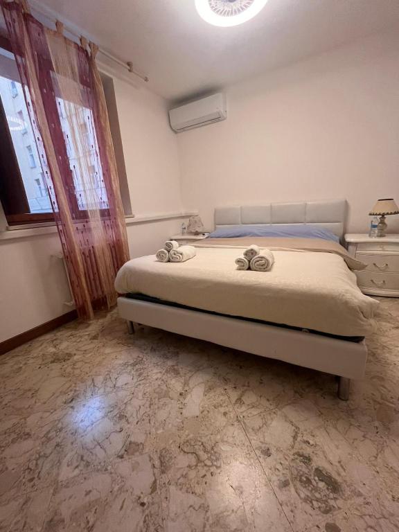 a bedroom with a bed and a large window at Al Castello 2 in Bari