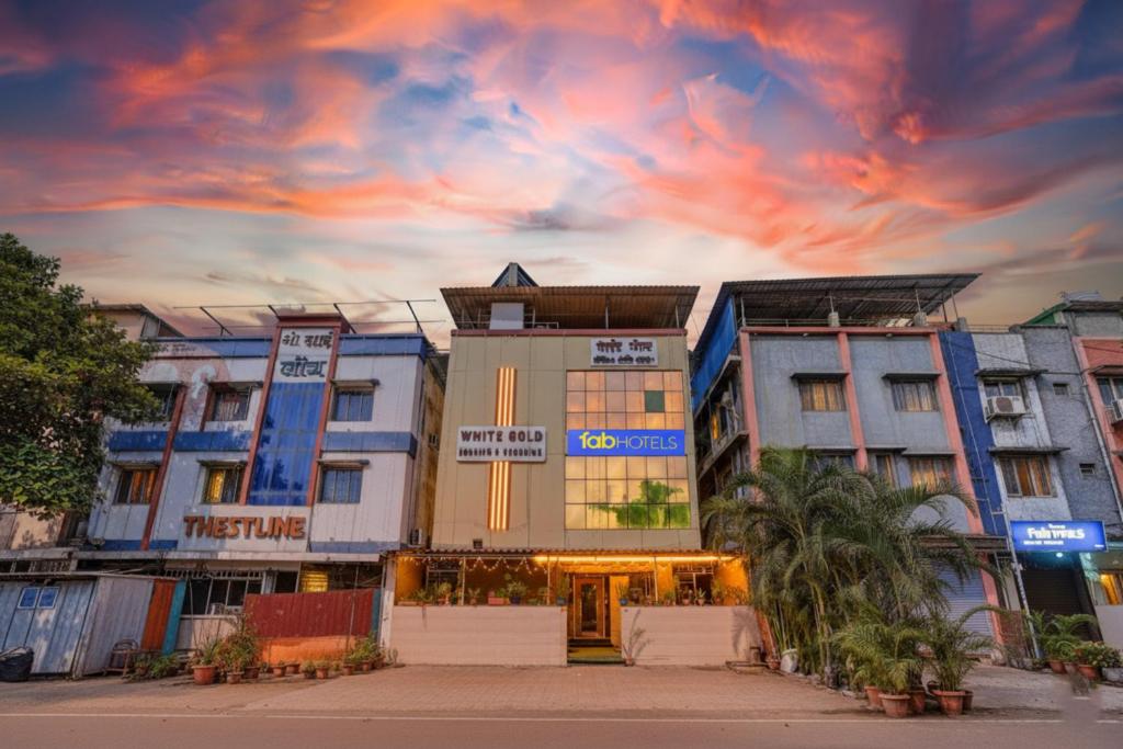 a group of buildings in a city at sunset at FabHotel White Gold - Nr Mahape in Ghansoli