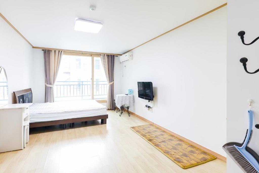 a hospital room with a bed and a tv at 온담펜션 