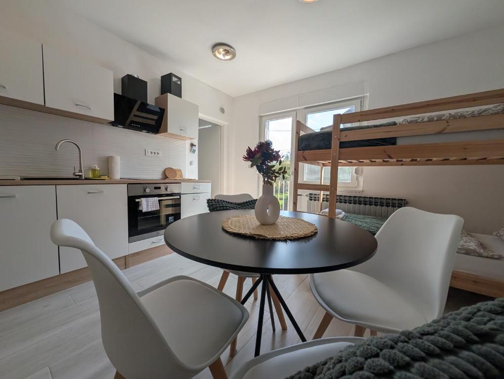 a kitchen and dining room with a table and chairs at Two Studios in Central Sesvete in Sesvete