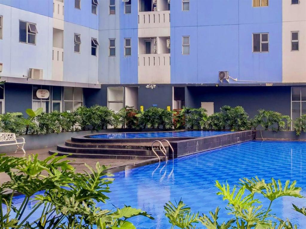 a swimming pool in the middle of a building at Antareja Urban Town By Reccoma in Dukuh