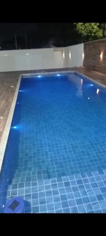 a large blue tile swimming pool with lights on it at casas em búzios 8 in Búzios