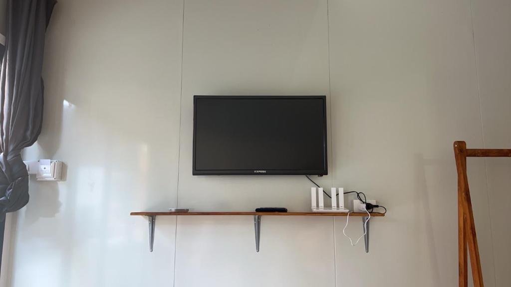 a flat screen tv hanging on a wall at Lipe Sea Sleep Homestay in Ko Lipe