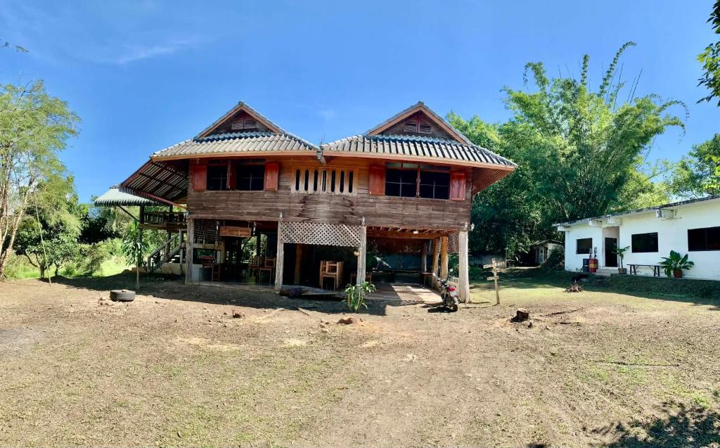 a large wooden house with a gambrel roof at Teak house pai in Ban Na Toeng Nai