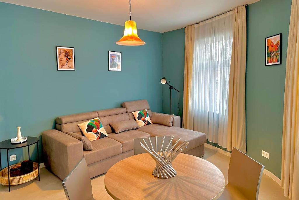 a living room with a couch and a table at Dokstudio50 in Ghent