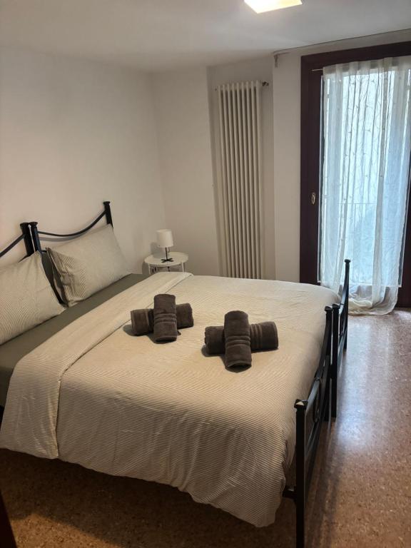 a bedroom with a large bed with two towels on it at la promenade in Vicenza