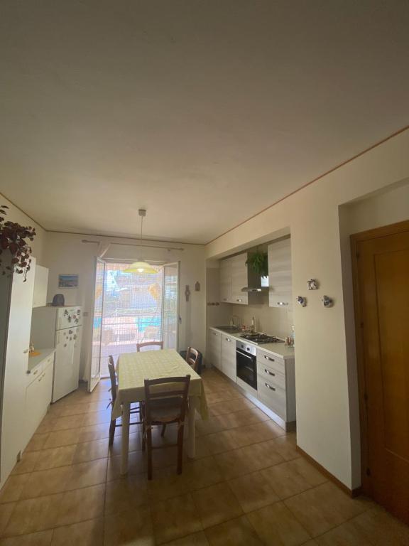 Crateri e coralli في ماسكالي: مطبخ مع طاولة وطاولة وكراسي