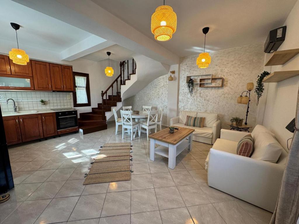 a living room with a couch and a table at Palm Villa in Skala Sotiros