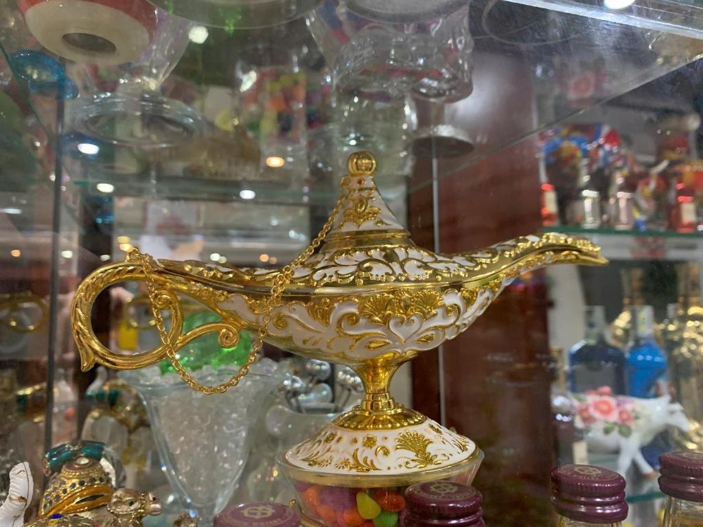 a gold bird vase on display in a glass case at Thanh Tùng Hotel in Can Tho