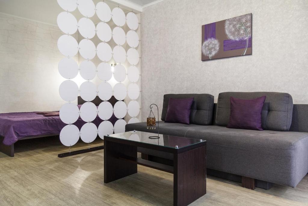 a living room with a couch and a table at Exclusive apartment at the in Mykolaiv