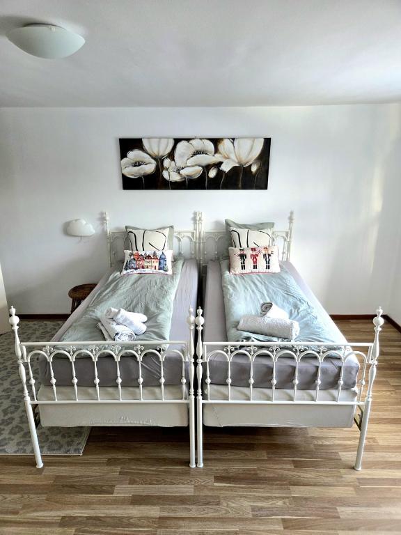 a bedroom with a white bed with two pillows at M & M home in Karlshamn