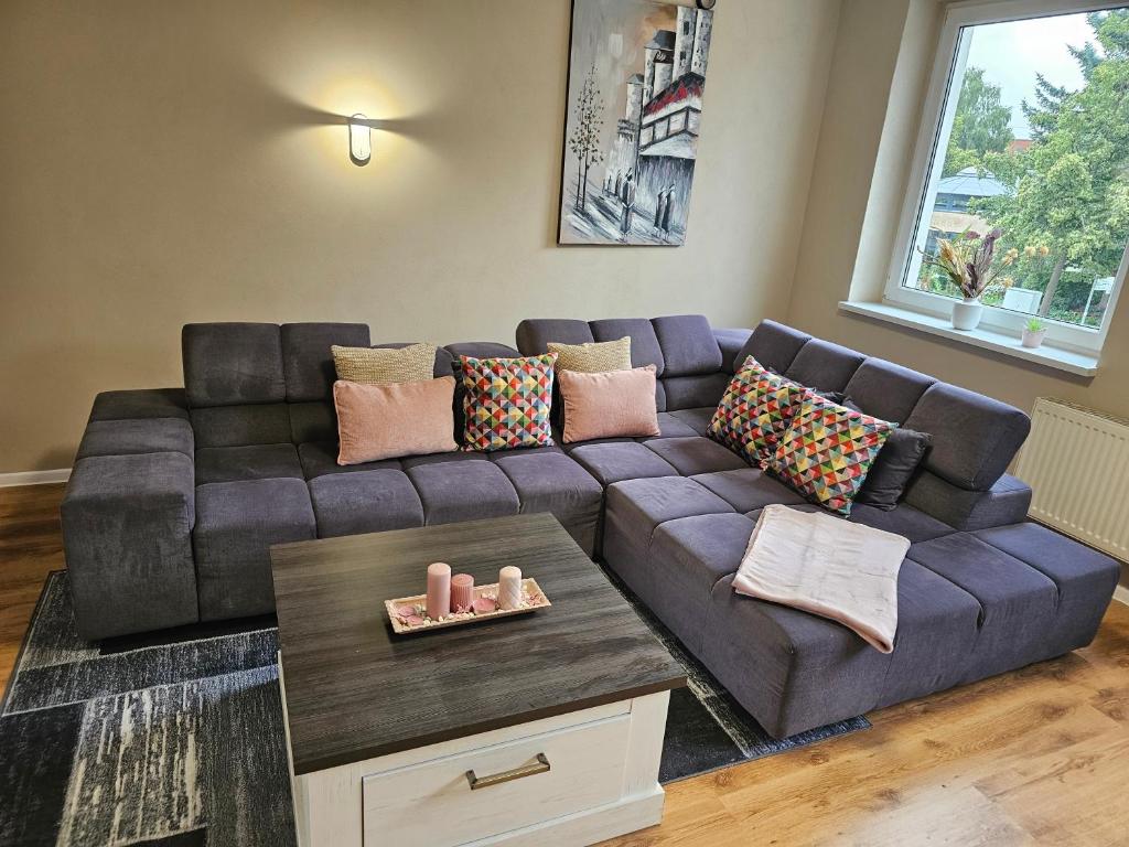 a living room with a purple couch with pillows at Seegarten in Görlitz