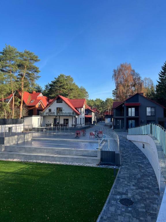 a park with stairs and benches and buildings at Gloria Hotel in Szack