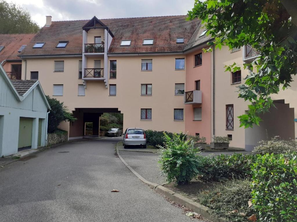 a white car parked in front of a building at Résidence le château Kaysersberg in Kaysersberg