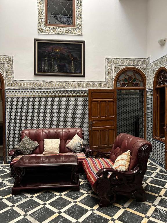 a living room with a couch and a chair at Maison EZ in Rabat