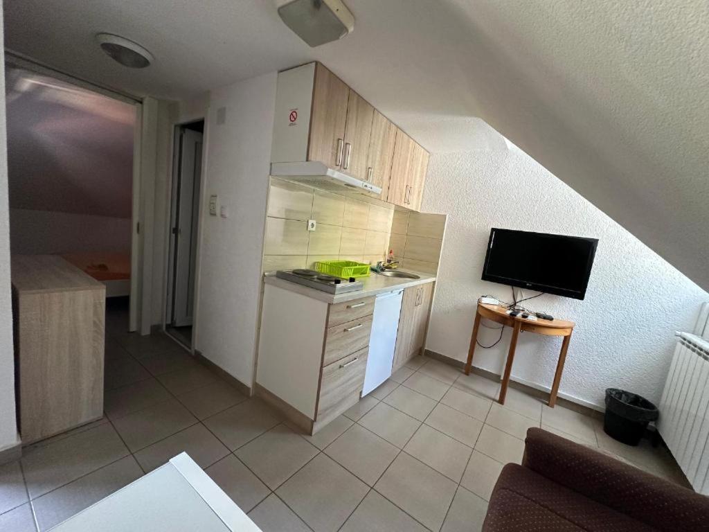 a small kitchen with a sink and a tv at Studio - Apartmani 3 in Jošanička Banja