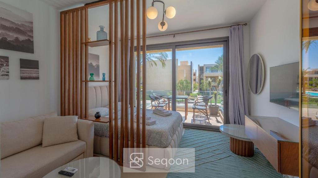 a living room with a couch and a table at Serenity Studio in G-Cribs in El Gouna