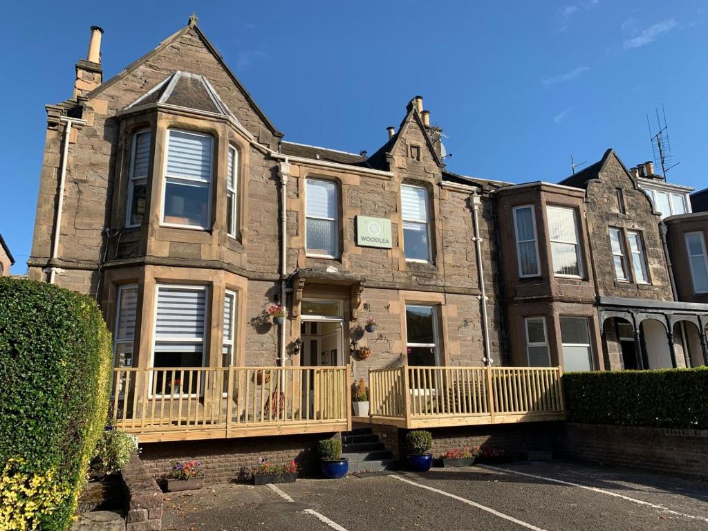 a large brick building with a porch and balcony at Woodlea in Perth