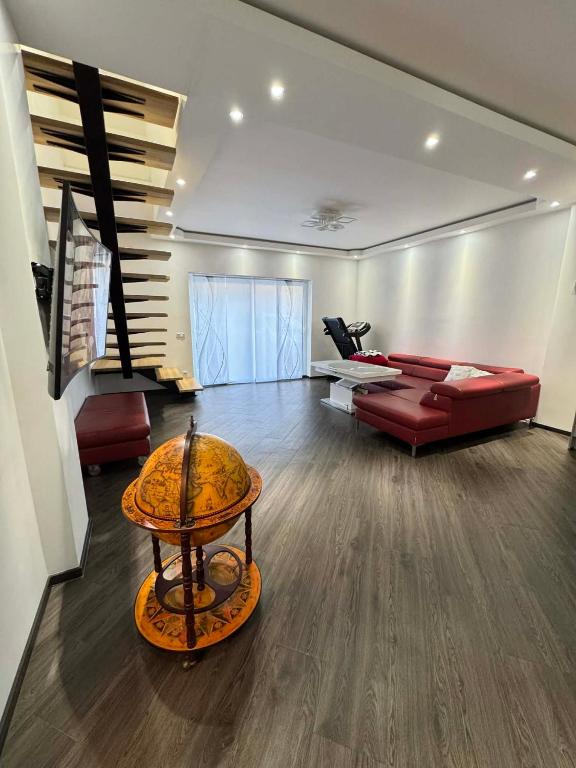 a living room with a red couch and a table at Apartament Bors in Ribnitz-Damgarten