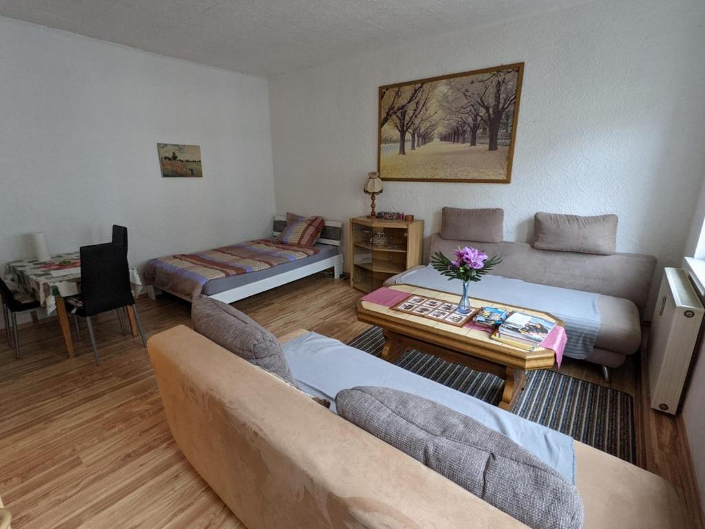 a living room with two beds and a couch at Gemütliche zentrale Wohnung in Eisenach