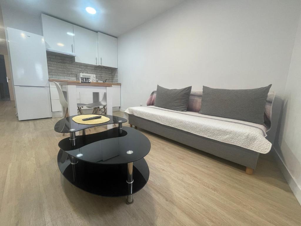 a living room with a couch and a table at Céntrico apartamento muralla 2 in Lugo