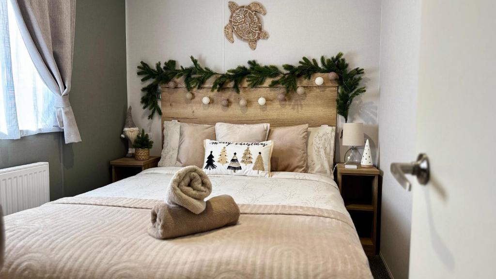 a bedroom with a bed with a towel on it at Big Boss Caravan-Camber Sands,Sleep 8, Free Wi-Fi, Netflix, Parking in Camber