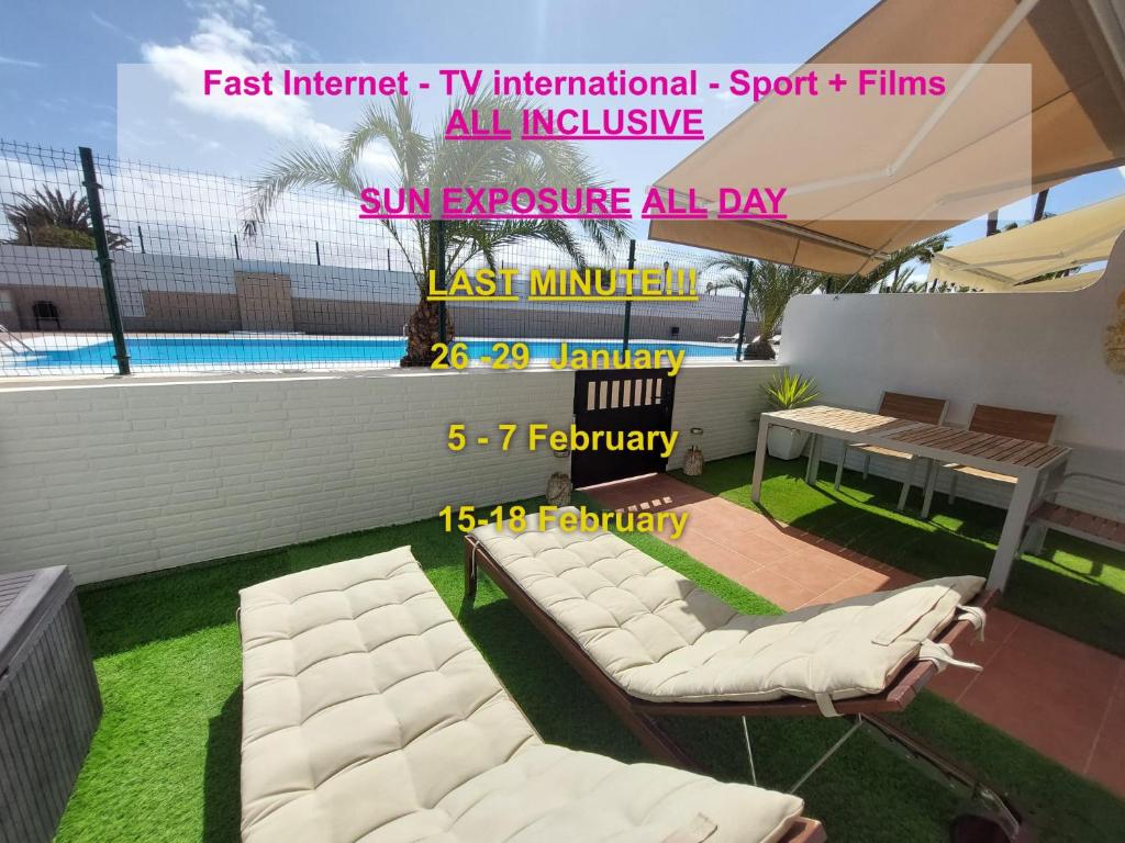 a rendering of a patio with white chairs and a pool at Sabai Holiday Home in Corralejo