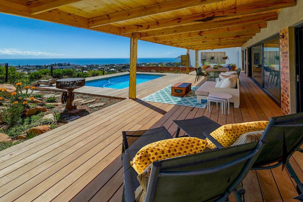a wooden deck with a view of a swimming pool at StonenSea in Plettenberg Bay