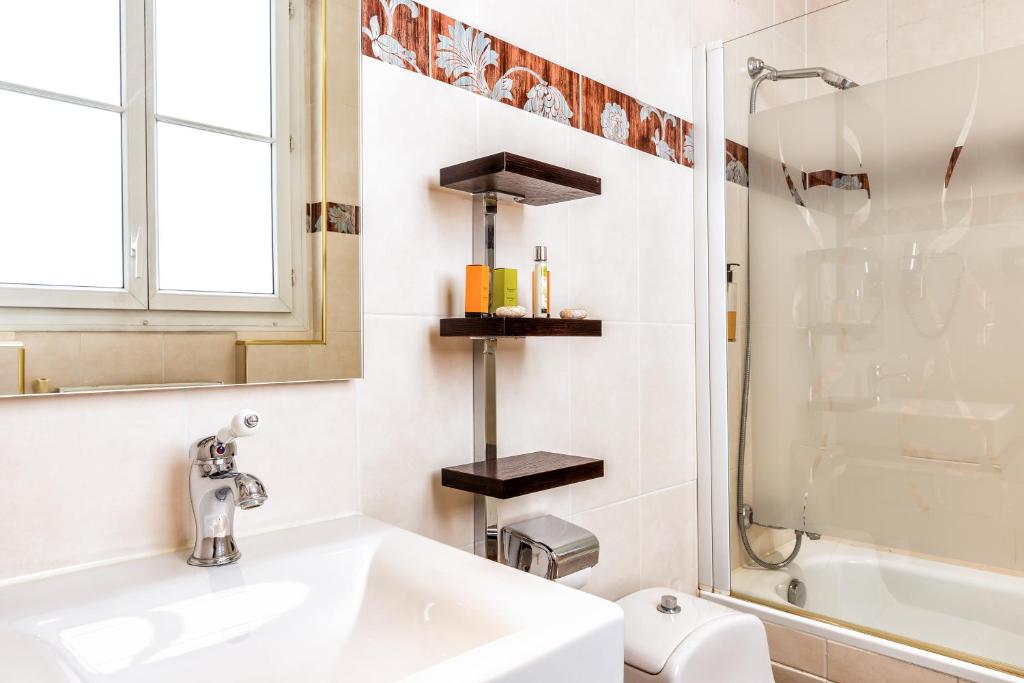 a bathroom with a sink and a toilet and a shower at Hotel Regence Paris in Paris