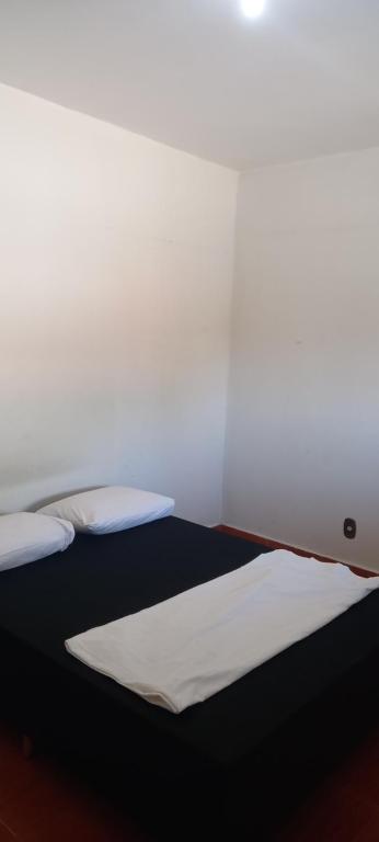 贝洛奥里藏特Casa aconchegante的床上有2个白色枕头