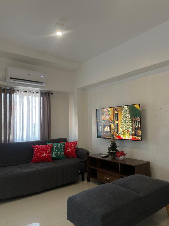 a living room with a couch and a table at The Penthouse Suite in Pusok