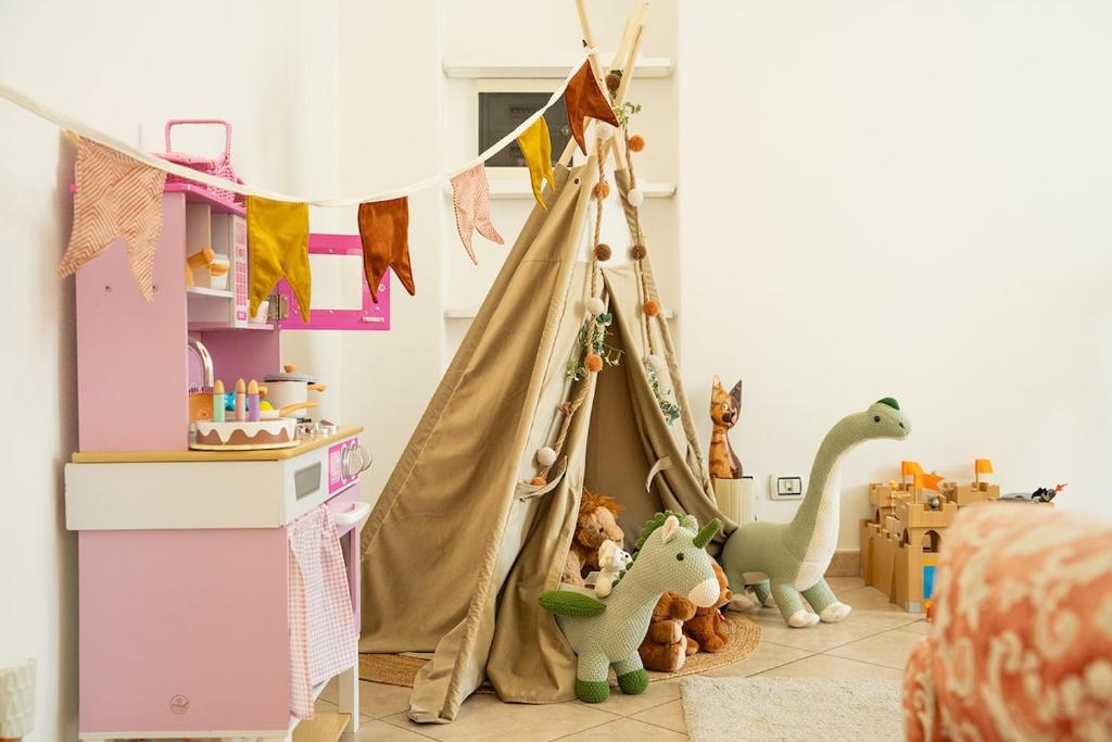 a childs room with a teepee tent and toys at The Lantern Lake View Apartment in Valsolda