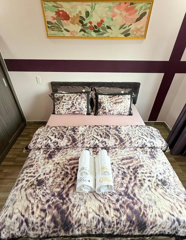 a bed with two pillows on top of it at LYSA Hotel in Xóm Ðèn