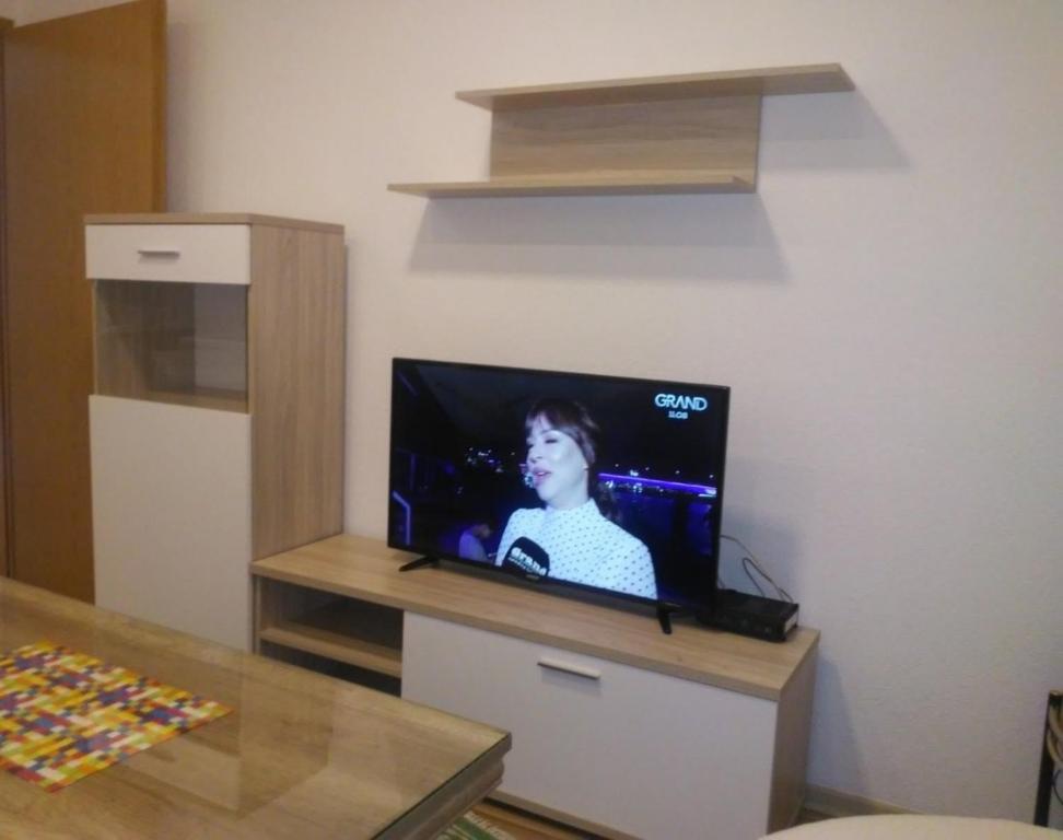 a flat screen tv sitting on a stand in a room at Daily rental apartment Travnik in Travnik