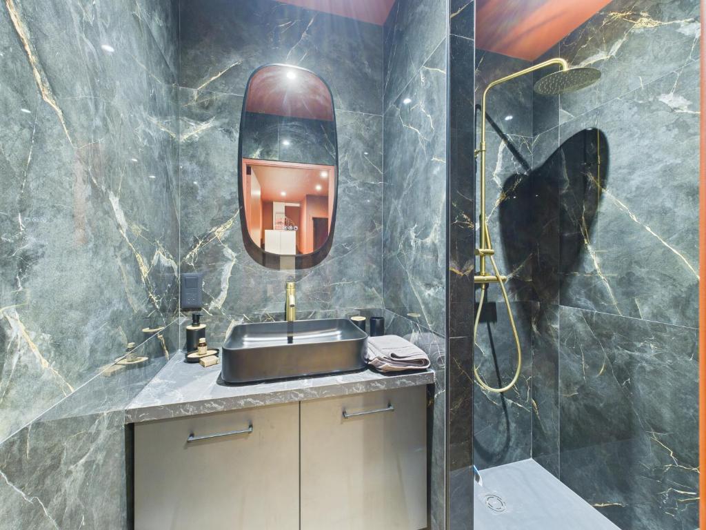 a bathroom with a sink and a shower at Ciné-Ponot in Le Puy en Velay