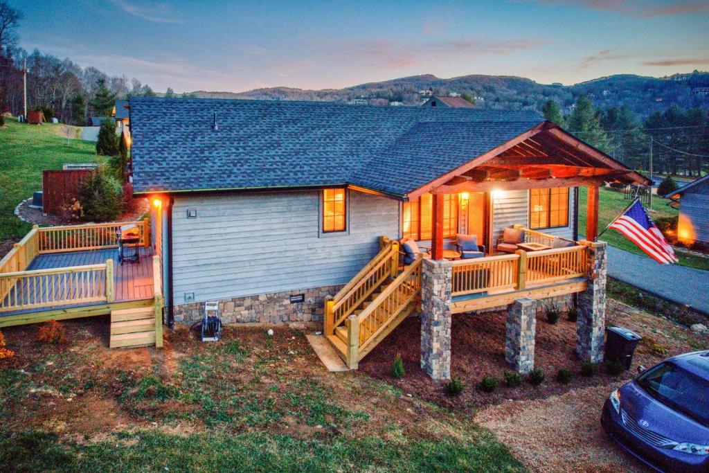 a log home with a large porch and a large deck at Banner Bear in Banner Elk