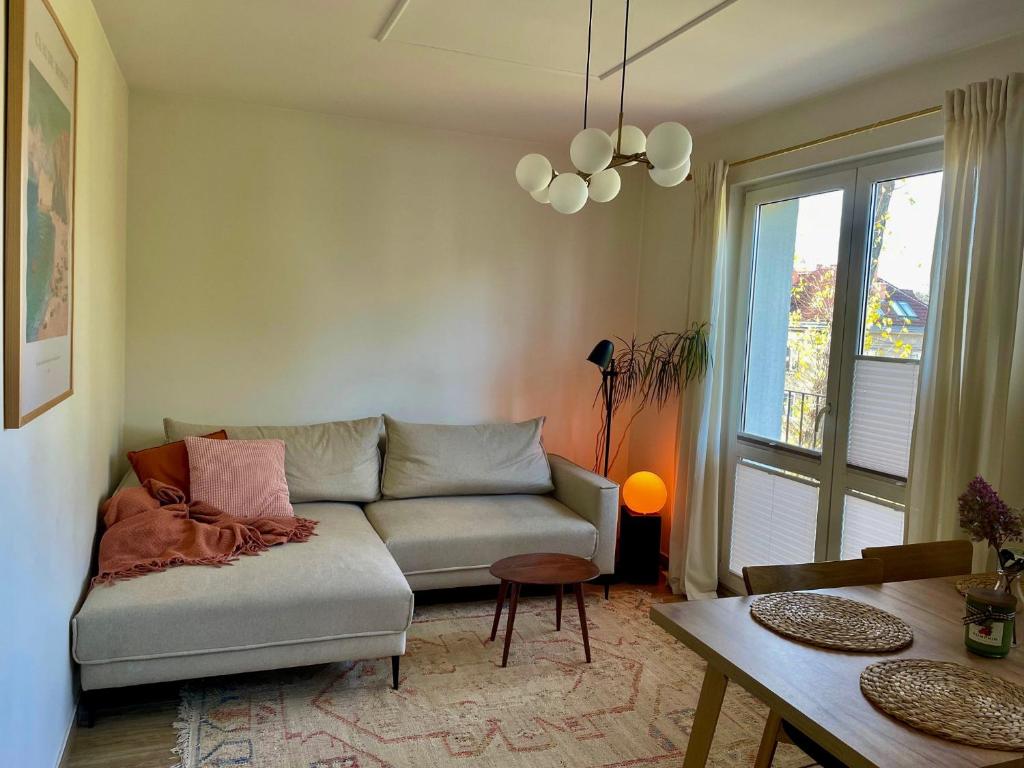 a living room with a couch and a table at Apartament przy Norweskim in Jelenia Góra