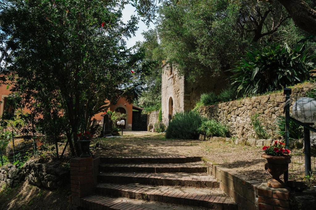 a stone building with stairs and a stone wall at Agriturismo Marzilio in Ficarra