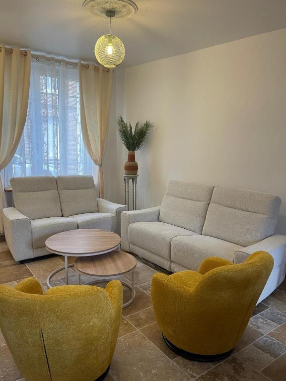 a living room with a couch and chairs and a table at Comfort with garden in Fécamp