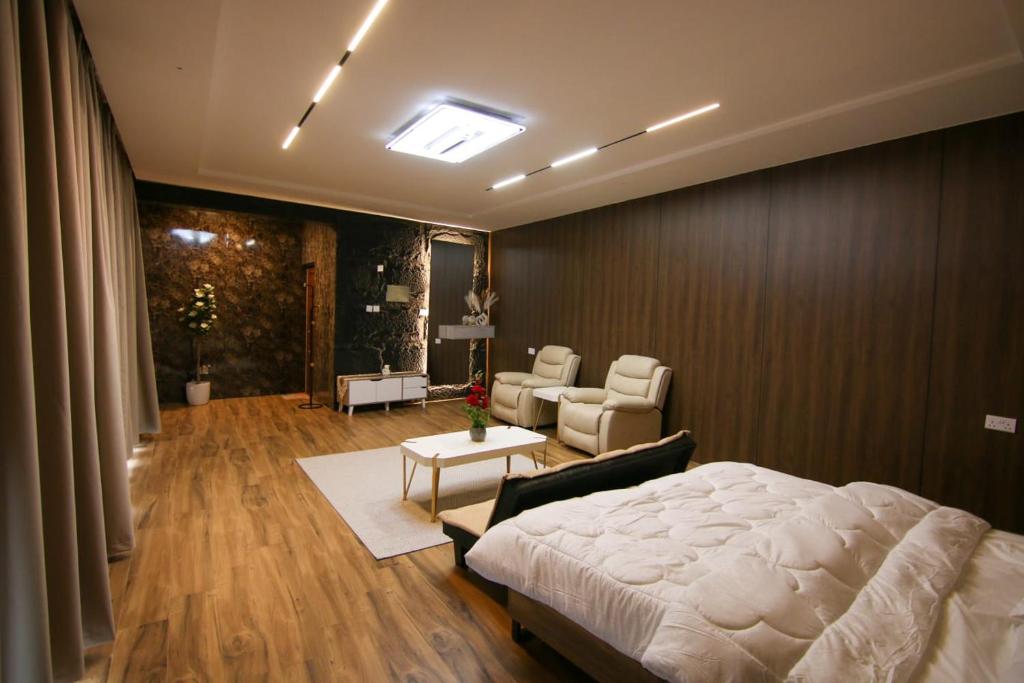 a bedroom with a bed and a living room at كهف الريف Reef Cave in Al Ḩamrāʼ