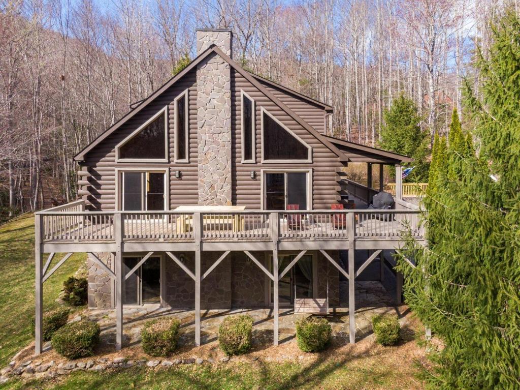 a log cabin with a porch and a deck at Whiskey Bear Escape in Fleetwood