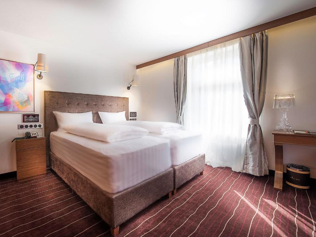 Postel nebo postele na pokoji v ubytování arthausHOTEL