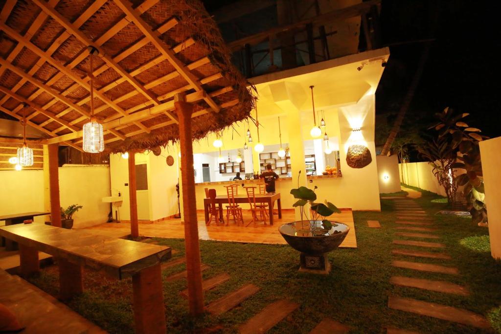 a pavilion with a table and a dining room at White Lion Paradise Dikwella in Batigama