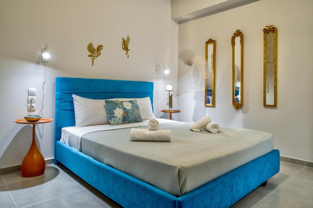 a bedroom with a blue bed in a room at Kozimo boutique katoikia in Patra