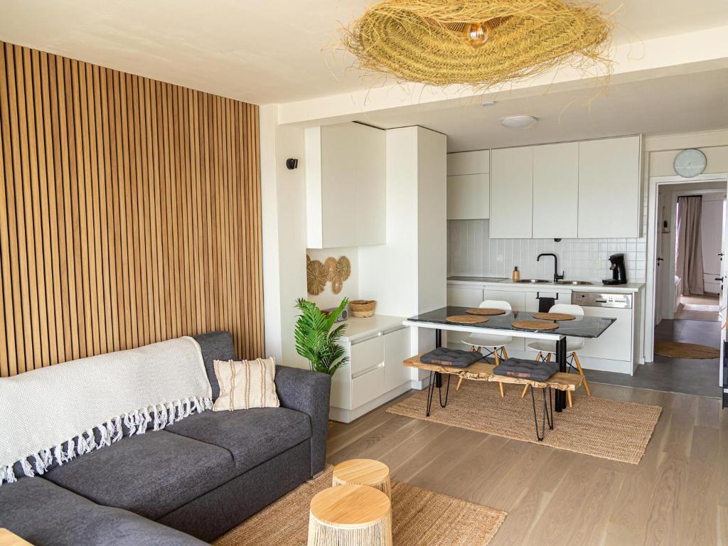 a living room with a couch and a kitchen at Nautilus - 0903 in Westende-Bad