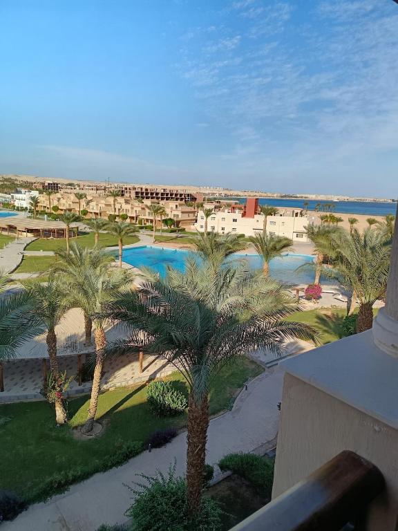 a view of a resort with palm trees and water at ParadiseHotel in Banī Ghālib