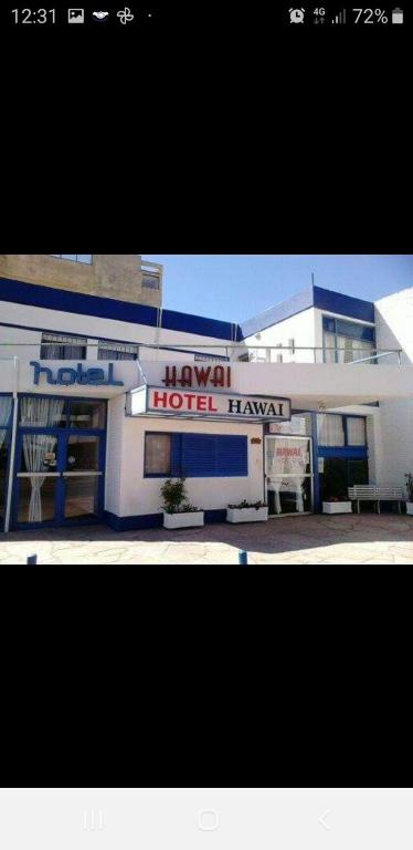 a building with a hotel hazard sign in front of it at Hotel Hawai in Villa Carlos Paz